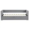 A grey upholstered daybed with a wooden slat mattress base and a pull-out drawer underneath. Produktbild-Vorschau