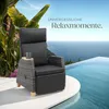 A rattan armchair with a side table and mug sits on a patio next to an infinity pool with a view of the ocean. Náhled obrázku produktu