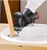 A person is using a cordless drill to attach a wooden leg to a white surface. Produktbild-Vorschau