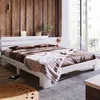 A bedroom scene with a white bed, brown bedding, and a wooden accent wall. Náhled obrázku produktu