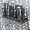 A set of screwdrivers on a dark gray holder, mounted on a pegboard. Produktbild-Vorschau
