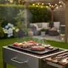 A backyard scene with a grill and food. Produktbild-Vorschau