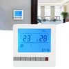 A thermostat panel with an LCD display is shown, with a smaller thermostat on a wall in the background and a blurred interior scene behind it. Voir les images du produit
