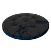A round, tufted cushion with blue trim and ties, shown from a slightly elevated side angle against a white background. Produktbild-Vorschau