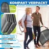 A couple walking out of a doorway, carrying bags. Produktbild-Vorschau