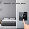A smart thermostat is shown mounted on a wall next to a bed in a bedroom. A hand is touching the screen of the thermostat. Produktbild-Vorschau