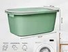A green laundry basket with dimensions and feature icons shown next to a washing machine. Produktbild-Vorschau
