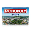 The image shows the front of a Monopoly board game box featuring a city skyline and the Monopoly logo. Produktbild-Vorschau