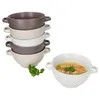 A stack of soup bowls and one filled soup bowl. Produktbild-Vorschau