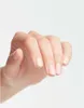 A close-up shot of a hand with light pink nail polish. Náhled obrázku produktu