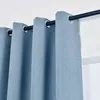 Close-up view of blue blackout curtains hanging from a rod. Produktbild-Vorschau