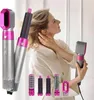 A woman is styling her hair with a hair dryer and attachments. Produktbild-Vorschau