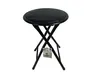 A black folding stool with a round seat and crossed legs, a tag hanging from the legs. Anteprima dell’immagine prodotto