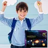 A young boy wearing a backpack and holding small planet-like objects, with a product box in the foreground. Náhled obrázku produktu