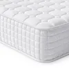 A close-up, angled view of a white mattress, showing its quilted surface and side texture.