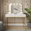 A vanity table with a lighted mirror, makeup, and a plant in a room. Produktbild-Vorschau