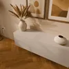 A modern living room with a lowboard, a vase with dried flowers, and artwork on the wall. Náhľad obrázku produktu