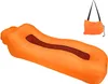 An orange inflatable lounger and a small orange bag with a black strap. Produktbild-Vorschau