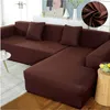 A brown sectional sofa covered with a slipcover. Produktbild-Vorschau