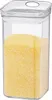 A clear, square plastic storage container filled with yellow granular material, likely polenta or cornmeal, with a clear lid. Produktbild-Vorschau