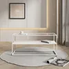 A modern living room setting with a white coffee table on a round gray rug. Náhled obrázku produktu