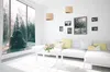 A modern living room with a large window overlooking a winter forest, featuring a white sectional sofa, a coffee table with flowers, and pendant lights. Náhľad obrázku produktu
