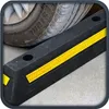 A close-up view of a car tire resting against a black parking bumper with yellow reflective stripes. Produktbild-Vorschau