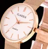 Close-up of a rose gold watch with a white face and mesh band. Produktbild-Vorschau