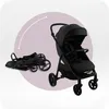 A black stroller is shown in two states: unfolded and folded, within a circular graphic. Náhľad obrázku produktu