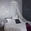 A bedroom scene with a bed decorated with a canopy and star-shaped pillows. Náhľad obrázku produktu