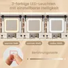 A close-up of a makeup mirror with LED lights, showing different light color options and a touch button. Voir les images du produit