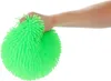 A hand squeezing a green puffer ball. Produktbild-Vorschau