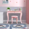 A pink vanity desk and stool set for children, with decorative elements on the wall and rugs on the floor. Náhľad obrázku produktu