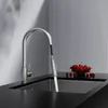 A modern kitchen sink with a pull-down faucet and a bowl of cherries. Produktbild-Vorschau