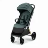A studio shot of a green and black stroller against a white background. Anteprima dell’immagine prodotto
