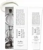 A product shot of a cream tube and its packaging, with a laboratory apparatus in the background. Podgląd zdjęcia produktu