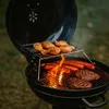A charcoal grill with food cooking on it. Produktbild-Vorschau