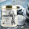 A tub of Kevin Levrone Gold Creatine supplement is shown next to a scoop of the powder, with weight plates in the background. Produktbild-Vorschau