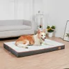 A dog is lying on a dog bed in a living room setting. Náhled obrázku produktu