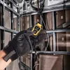 A gloved hand holds a DeWALT laser distance measurer in a construction environment. Anteprima dell’immagine prodotto