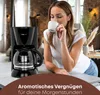 A woman is enjoying a cup of coffee next to a coffee maker. Náhľad obrázku produktu