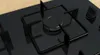 A close-up view of a black gas hob with a wok burner. Anteprima dell’immagine prodotto