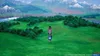 Two characters stand in a vast green landscape with mountains in the background. Produktbild-Vorschau