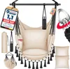 A beige hammock chair with black tassels, pillows, and accessories, displayed against a white background. Produktbild-Vorschau