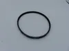 A black toothed belt is shown on a light gray surface. Produktbild-Vorschau