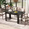 A dining table set up on a patio or sunroom, with chairs, plants, and a rug. Anteprima dell’immagine prodotto