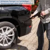 A person is using a pressure washer to clean a car wheel. Produktbild-Vorschau