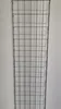 A wire mesh rack against a white wall. Anteprima dell’immagine prodotto