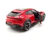 A red Bburago 1:24 scale model of a Ferrari Purosangue is shown from a rear-side angle with the driver's door open. Anteprima dell’immagine prodotto