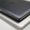 A close-up shot of two protective cases for a laptop, one black and one white, stacked on top of each other. Produktbild-Vorschau